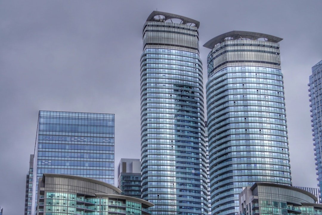 a-couple-of-tall-buildings-sitting-next-to-each-other-taacswpgpw4
